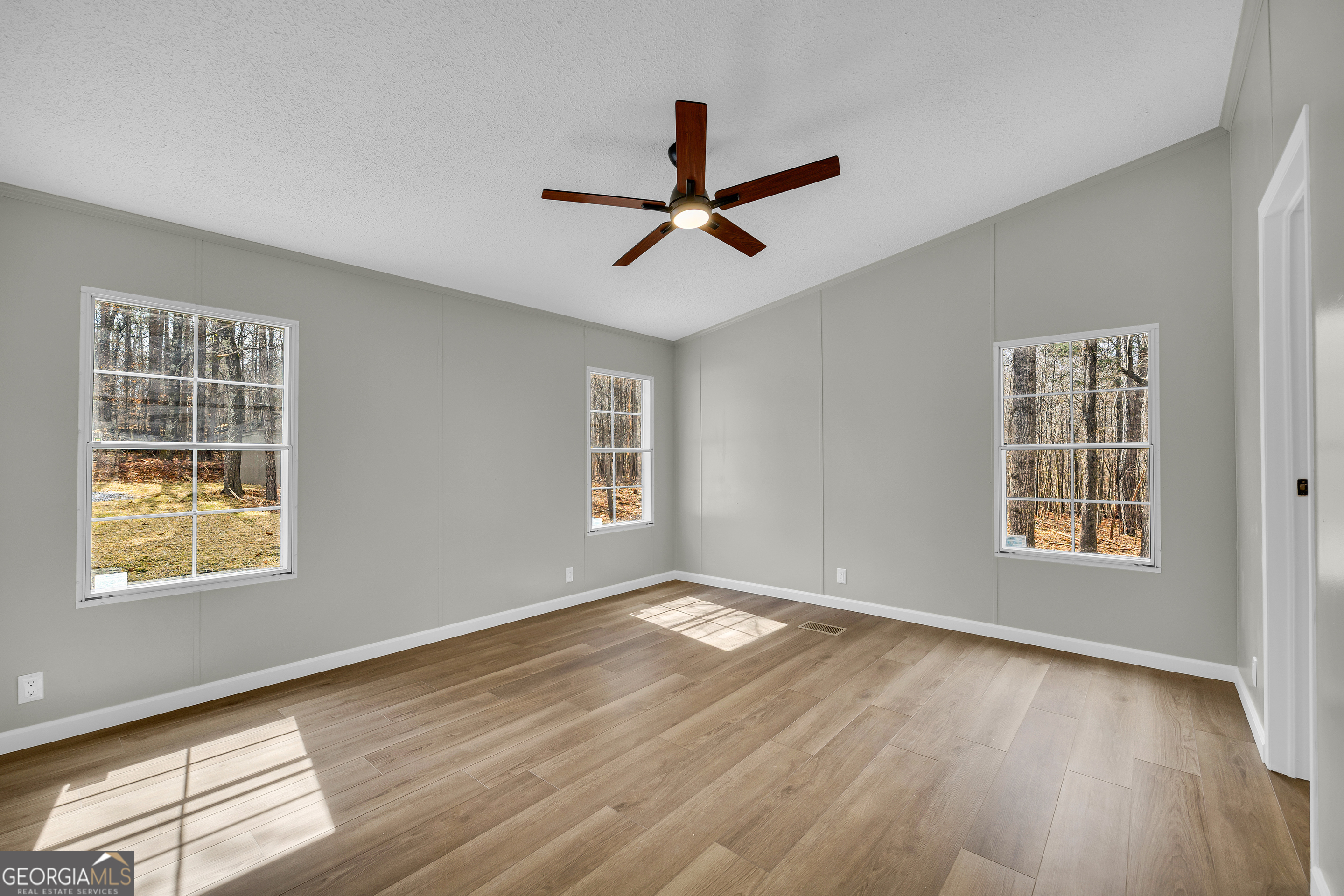 60 Tribble Bottoms Road Arnoldsville, GA 30619 - Photo 38 of 66 a view of an empty room with wooden floor and a window