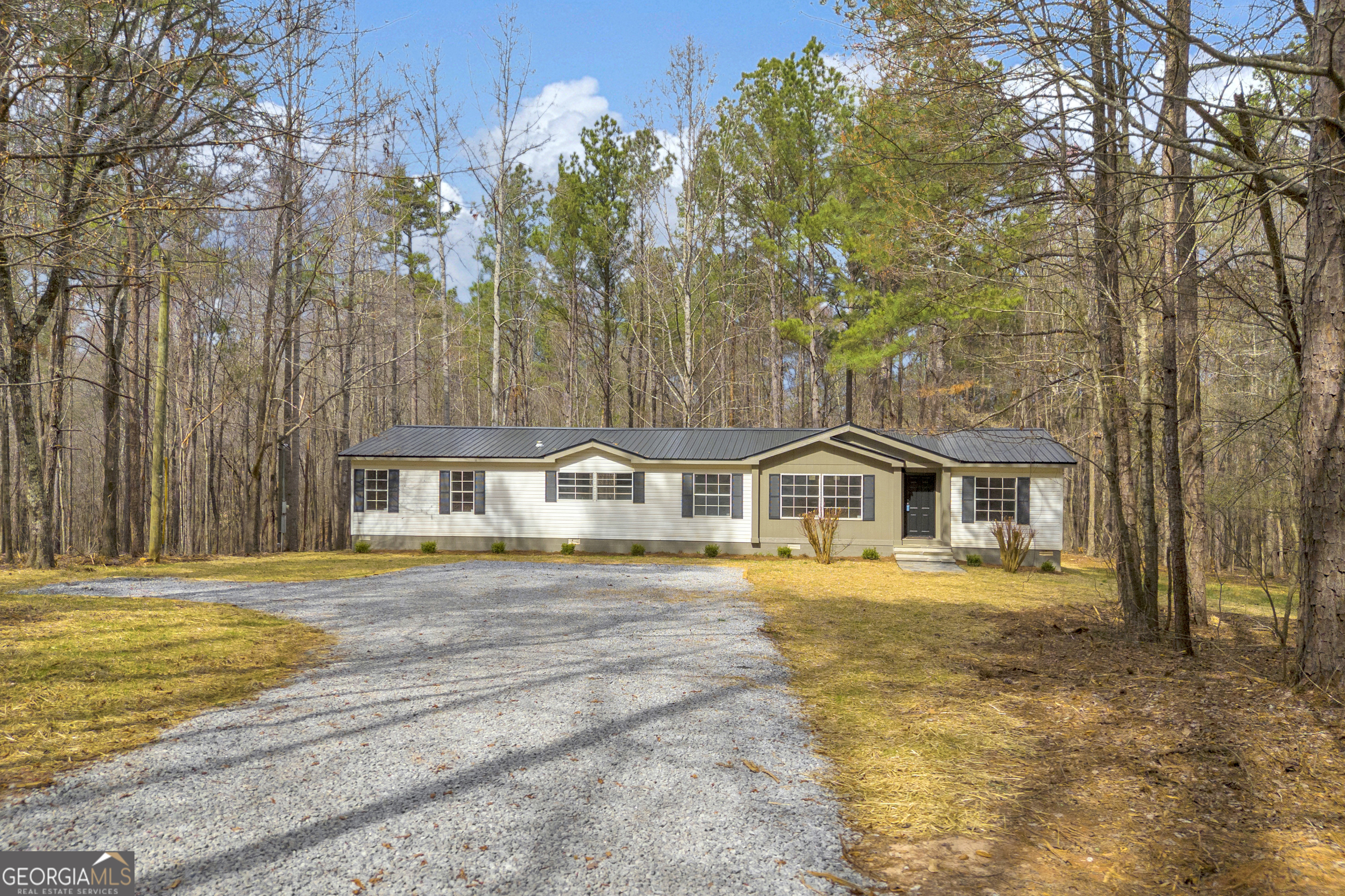 60 Tribble Bottoms Road Arnoldsville, GA 30619 - Photo 5 of 66 a front view of a house with a garden