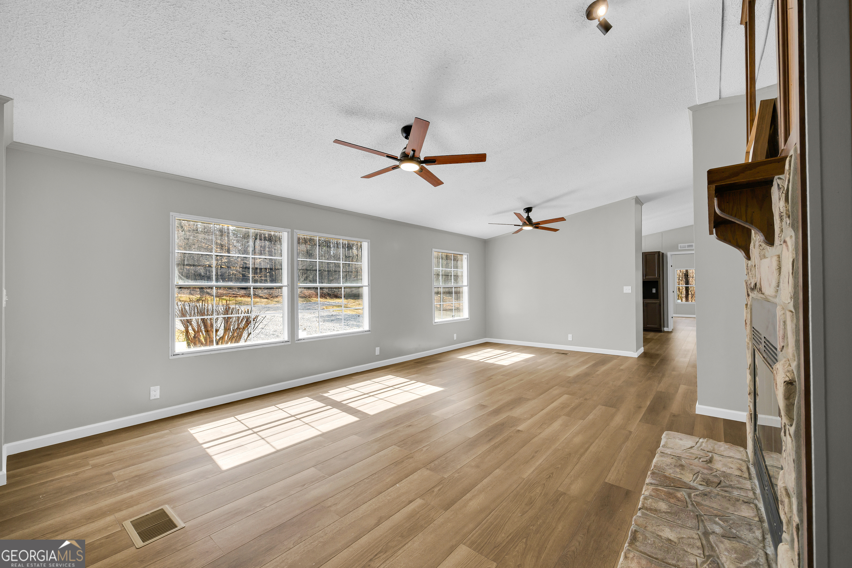 60 Tribble Bottoms Road Arnoldsville, GA 30619 - Photo 9 of 66 wooden floor in an empty room with a window