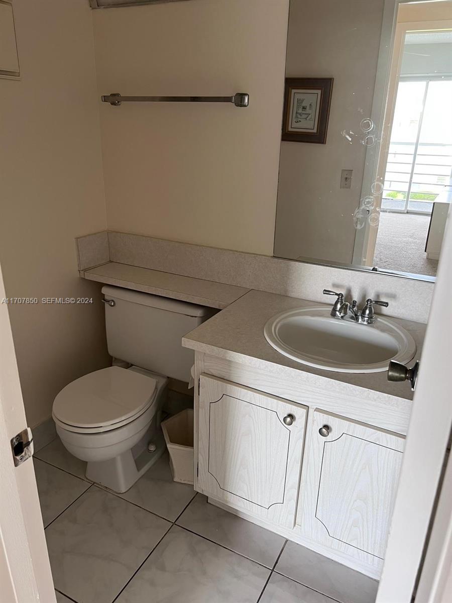 324 Fanshaw H, Unit 324H Boca Raton, FL 33434 - Photo 7 of 13 a bathroom with a sink and a toilet