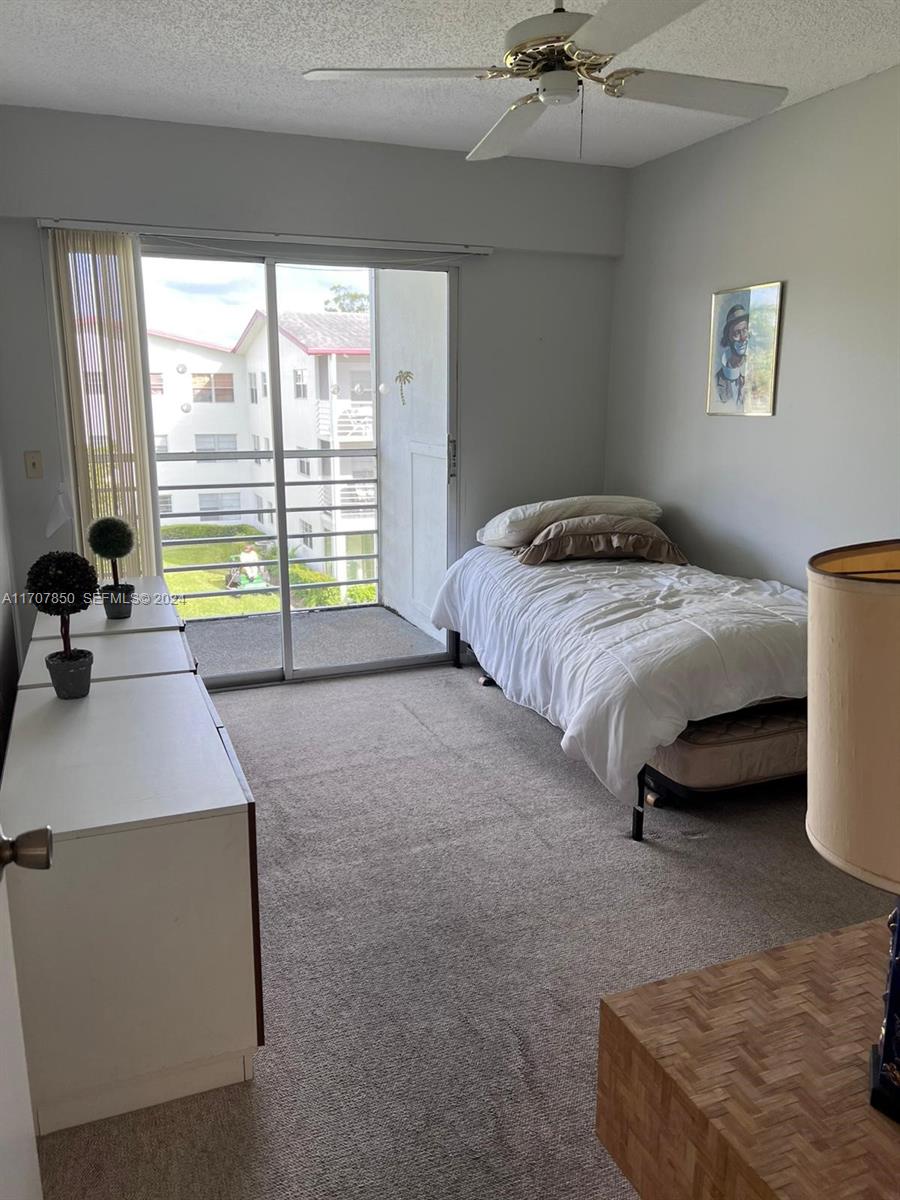 324 Fanshaw H, Unit 324H Boca Raton, FL 33434 - Photo 8 of 13 a bed sitting in a bedroom next to a window