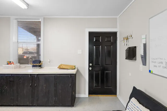 a room with a window and a mirror