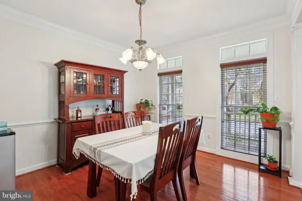 a view of a dining room with furniture wooden floor and chandelier