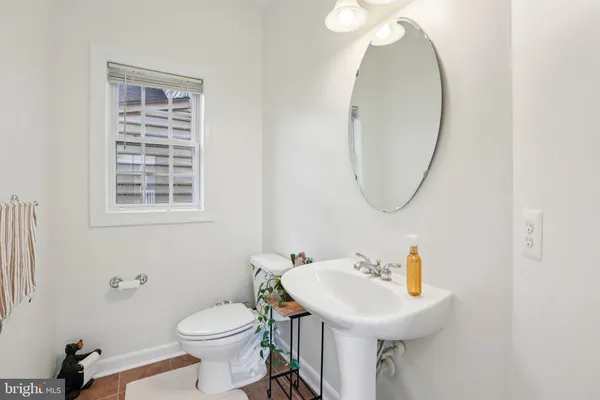 a bathroom with a sink a mirror and a toilet