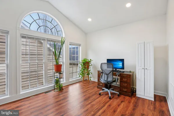 a view of a livingroom with workspace and a window