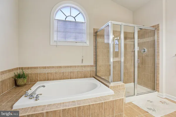 a bathroom with a tub and a shower