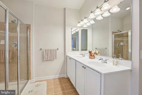 a bathroom with a sink a light fixture and a mirror