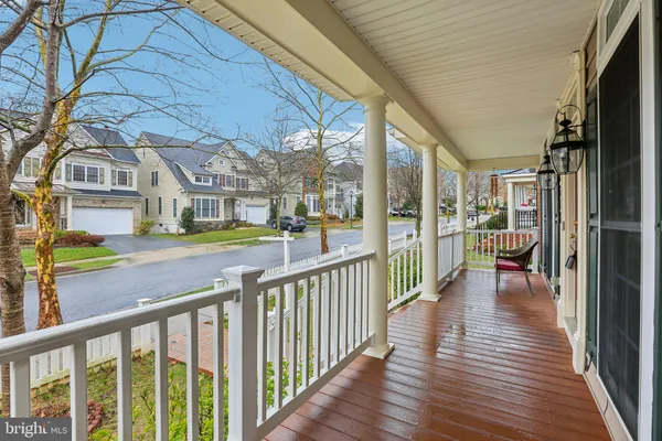 a view of a porch with wooden floor and fence