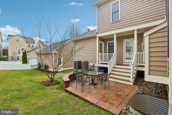 a house view with a sitting space and garden