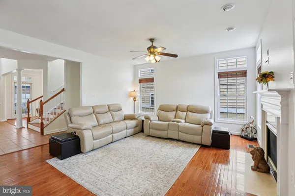 a living room with furniture wooden floor and a fireplace
