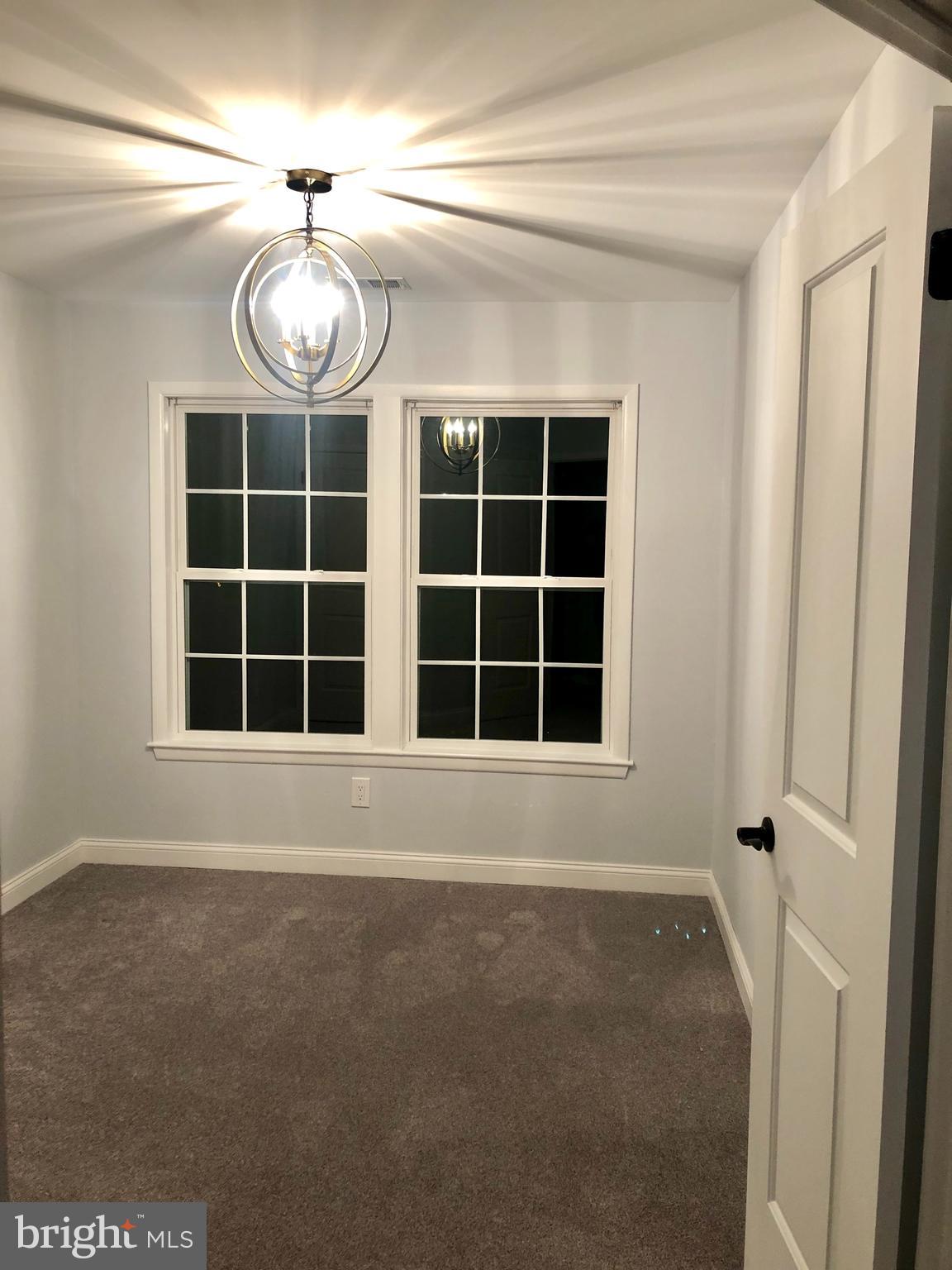301 Trinity Court, Unit 10 Princeton, NJ 08540 - Photo 12 of 19 a view of an empty room with a window and chandelier