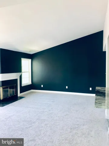 a view of an empty room with a fireplace