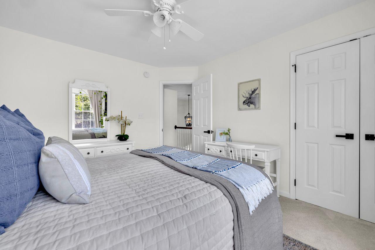 5616 Ryans Run Road East New Market, MD 21631 - Photo 34 of 56 a bedroom with a bed and a chandelier