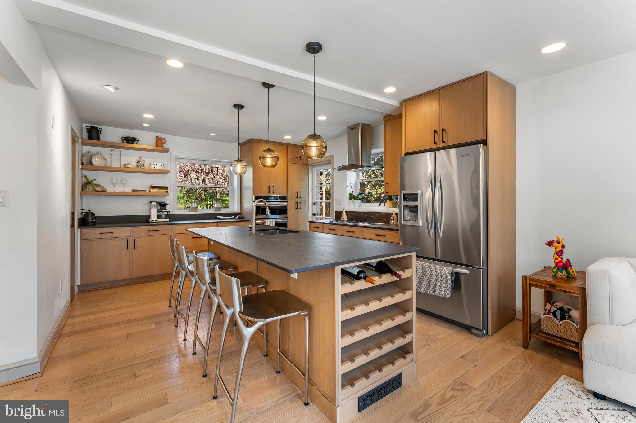 2820 Ellicott Street Northwest Washington, DC 20008 - Photo 10 of 43 a kitchen with stainless steel appliances a refrigerator a sink a stove a dining table and chairs