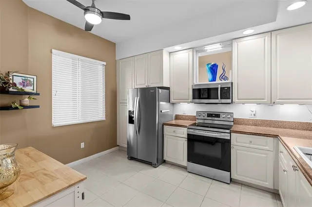 a kitchen with stainless steel appliances granite countertop a refrigerator sink and stove