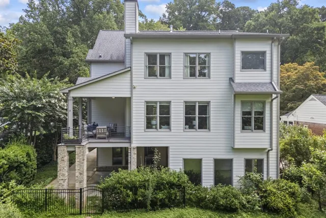 a view of a dining room with furniture a chandelier and wooden floor