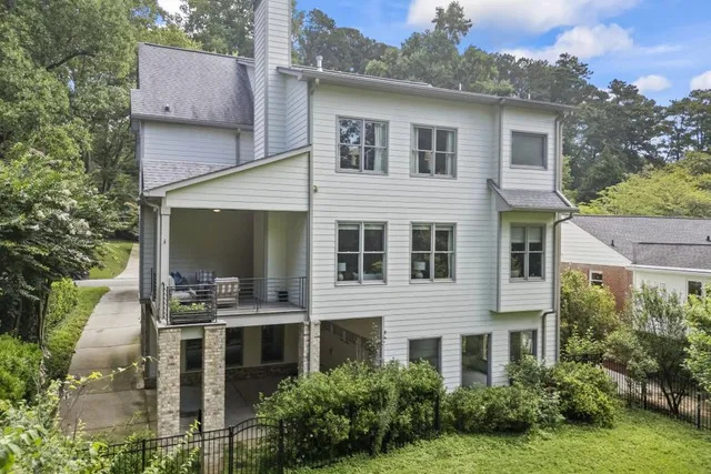 a view of a dining room with furniture a chandelier and wooden floor