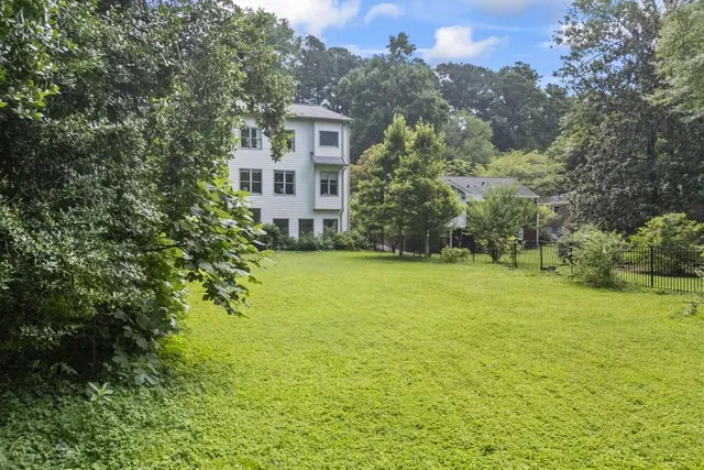 a kitchen with a sink white cabinets and appliances