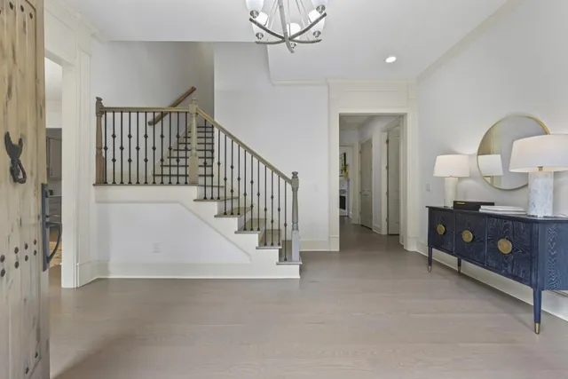 a kitchen with stainless steel appliances granite countertop a stove a sink dishwasher and cabinets with wooden floor