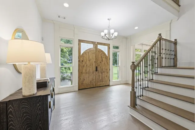a living room with furniture a fireplace and a large window