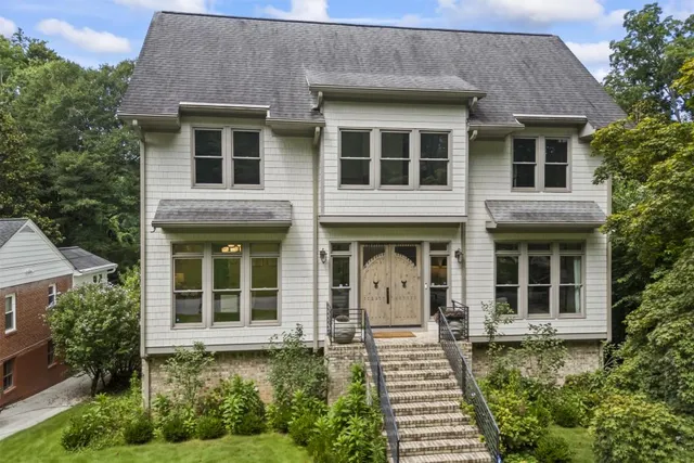 a front view of a house with a garden