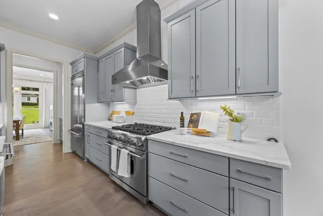 a bathroom with a double vanity sink a mirror and a bathtub