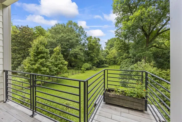 an aerial view of residential houses with outdoor space and trees