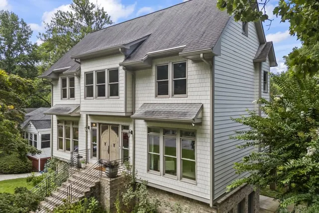 a front view of a house with a garden