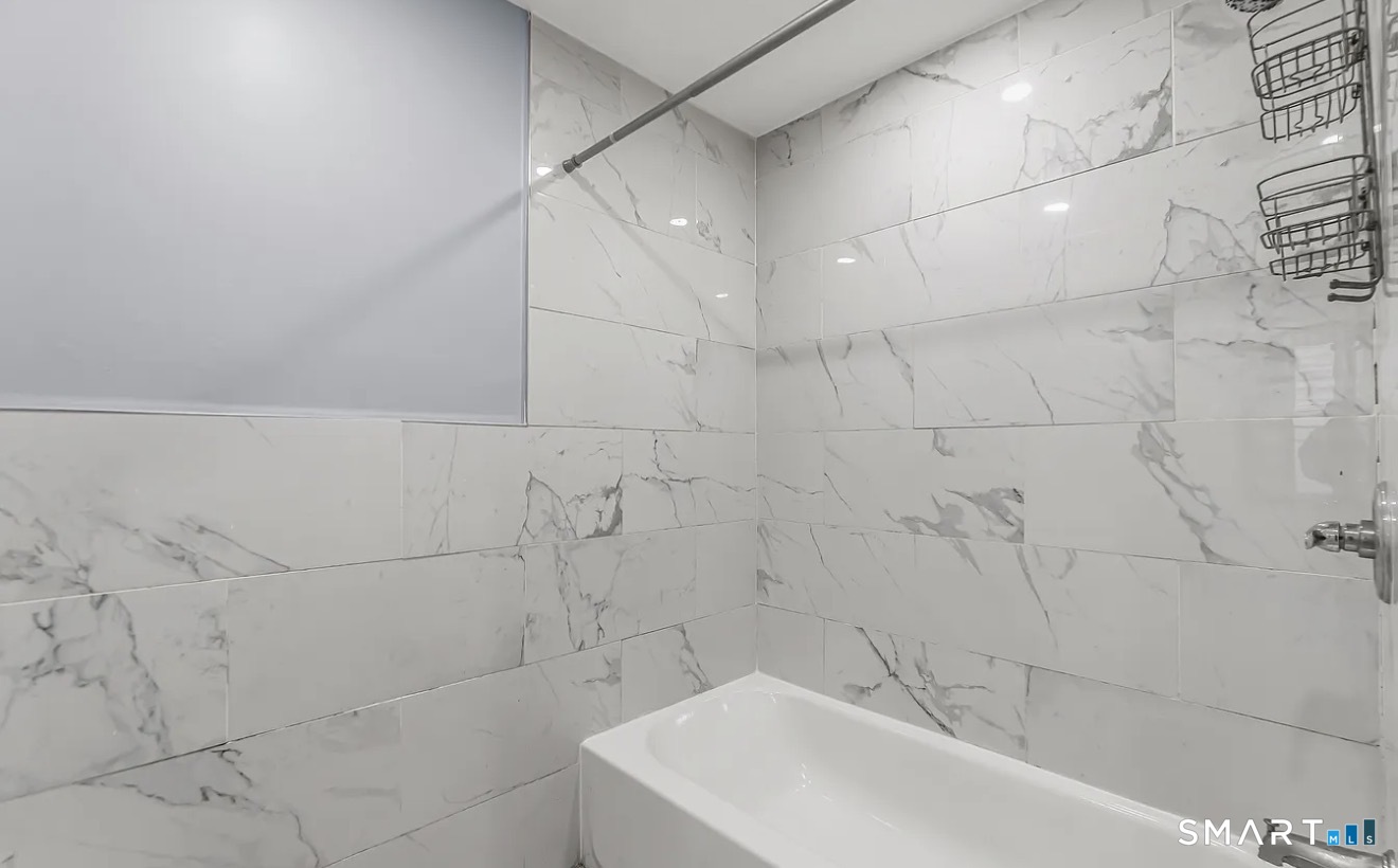 1220 Pembroke Street, Unit 3R Bridgeport, CT 06608 - Photo 12 of 12 a bathroom with a bathtub and shower