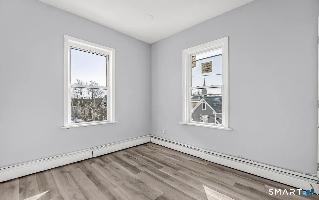 1220 Pembroke Street, Unit 3R Bridgeport, CT 06608 - Photo 4 of 12 an empty room with windows