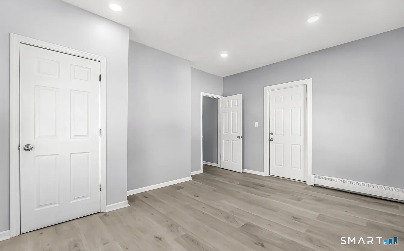 1220 Pembroke Street, Unit 3R Bridgeport, CT 06608 - Photo 6 of 12 an empty room with wooden floor & closet area