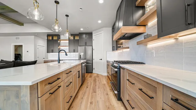a large kitchen with stainless steel appliances granite countertop a lot of counter space