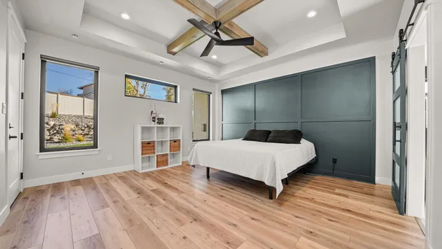 a bedroom with a bed and a chandelier