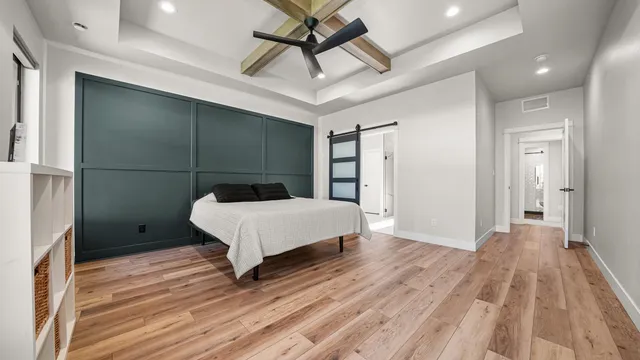 a bedroom with a bed and a ceiling fan