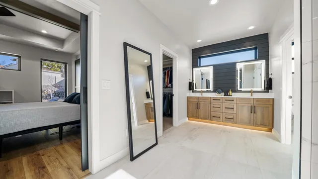 a bathroom with a sink a mirror and a shower