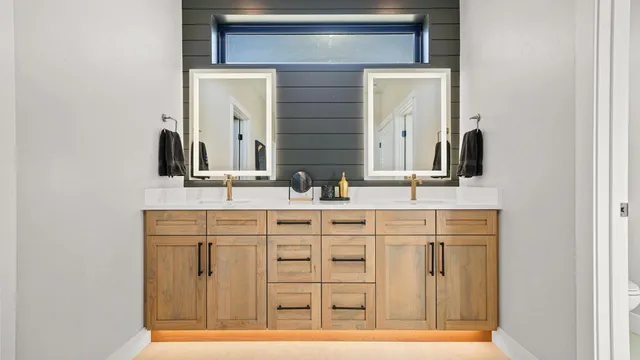 a bathroom with a double vanity sink and a mirror