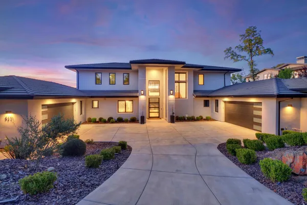 a front view of a house with a yard and garage