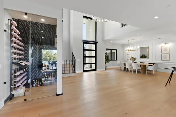 a spacious bathroom with a double vanity sink a large mirror and a bathtub