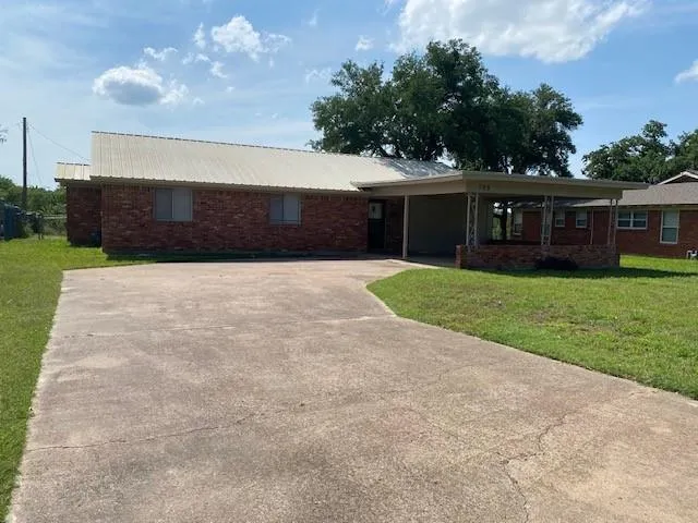 a front view of house with yard and garage