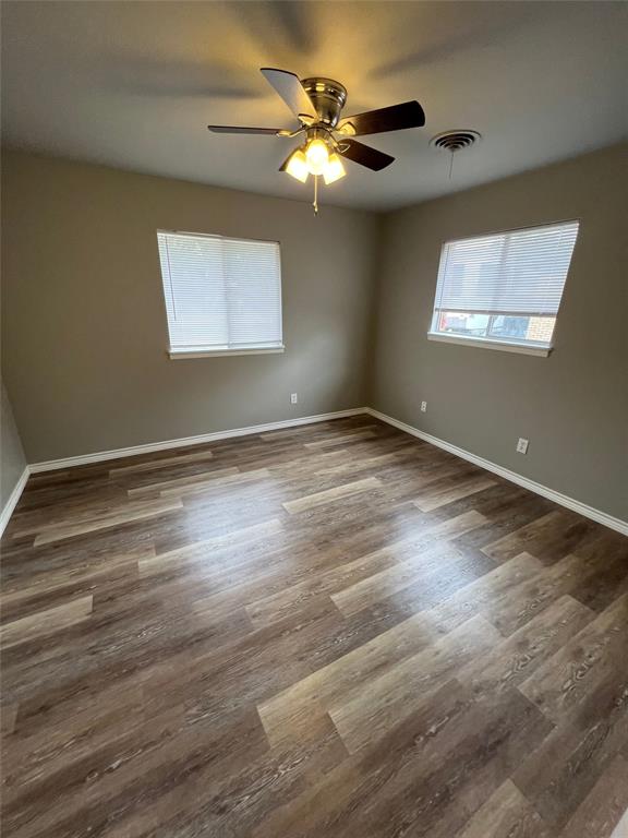 105 Oak Ridge Terrace Weatherford, TX 76086 - Photo 13 of 21 a view of an empty room with wooden floor and a window