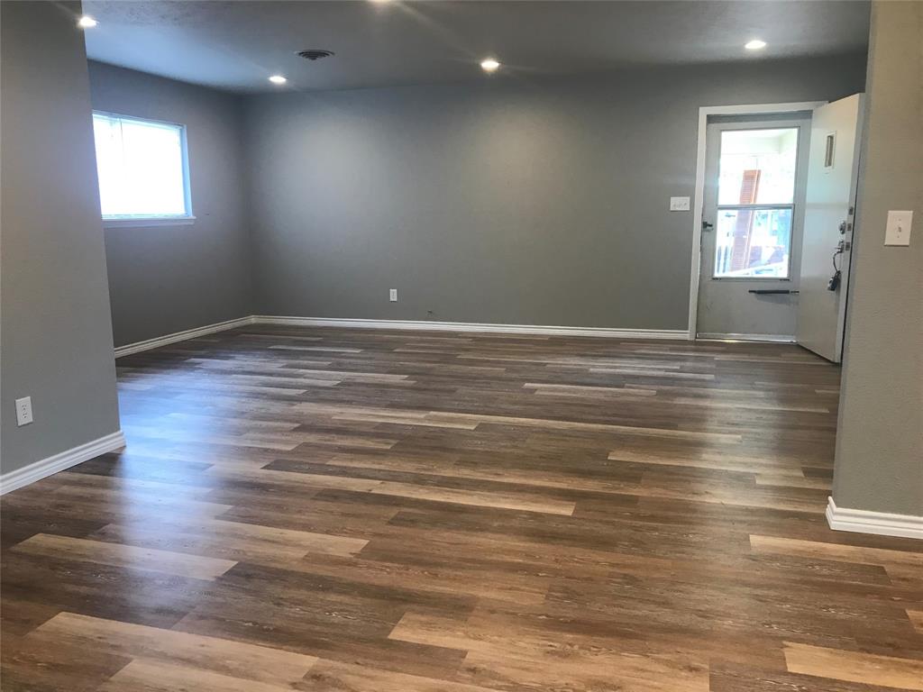 105 Oak Ridge Terrace Weatherford, TX 76086 - Photo 7 of 21 an empty room with wooden floor and windows