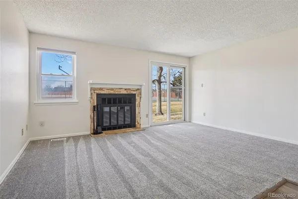 a kitchen with stainless steel appliances granite countertop a stove and a microwave with white cabinets