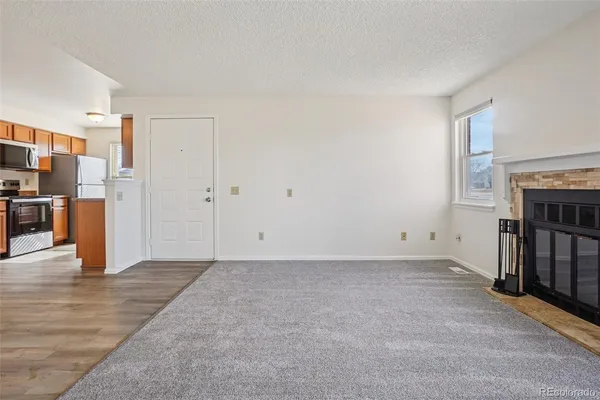a view of kitchen with wooden floor electronic appliances and window
