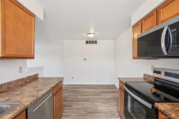 a view of a kitchen with a sink and a stove top oven