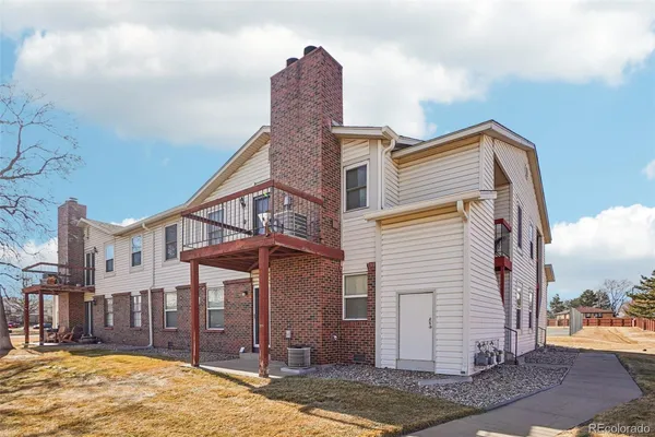 a swimming pool with outdoor seating area and barbeque oven