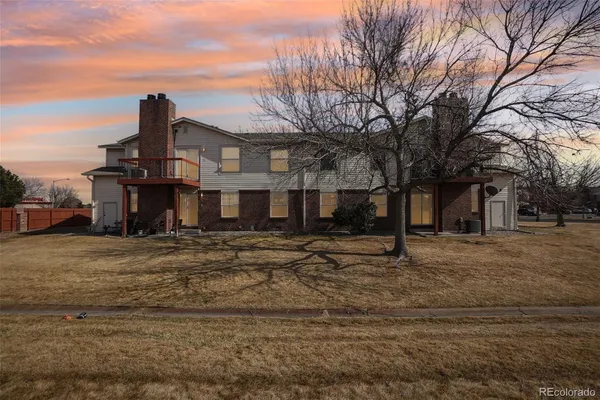 a view of a house with wooden fence