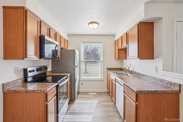 a kitchen that has a sink and a stove