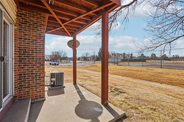 a view of empty room with a kitchen