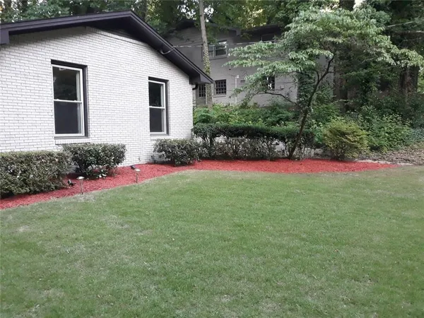 a view of a backyard of the house