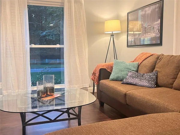a dining room with furniture and wooden floor
